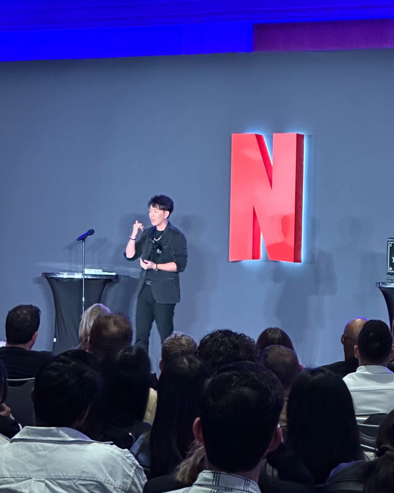 Johnny Wu on stage at a Netflix event