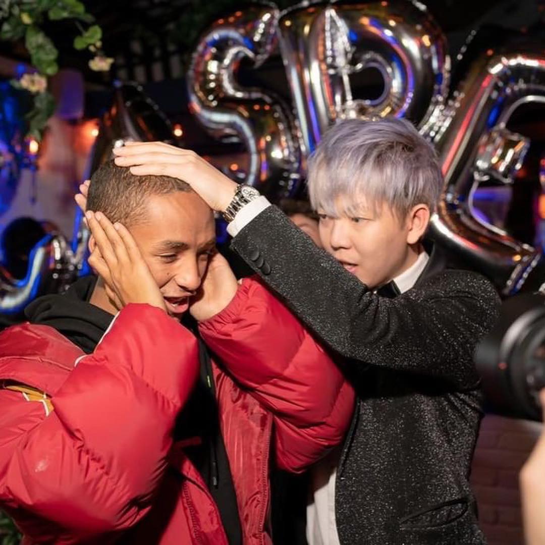 A father and son reacting at a private party