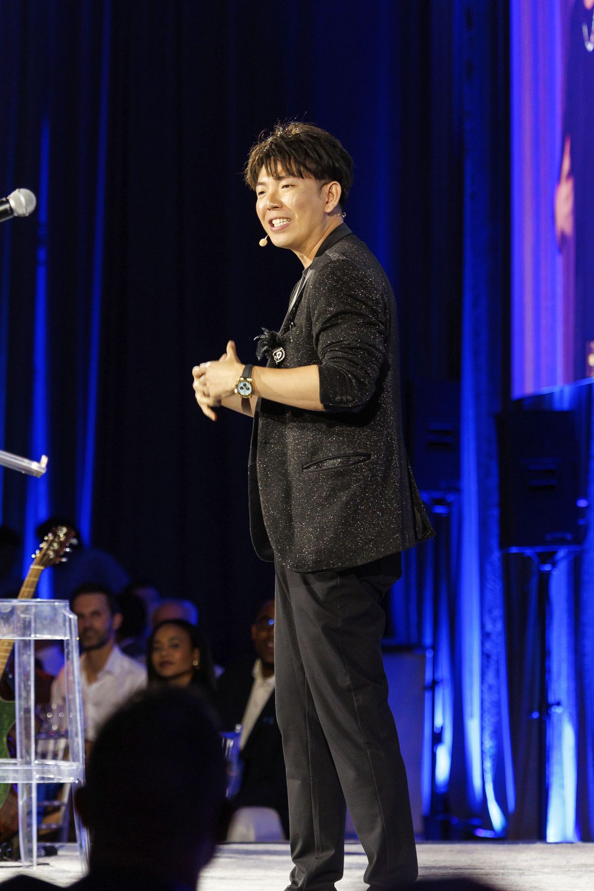 Johnny Wu performing a stage show at a gala