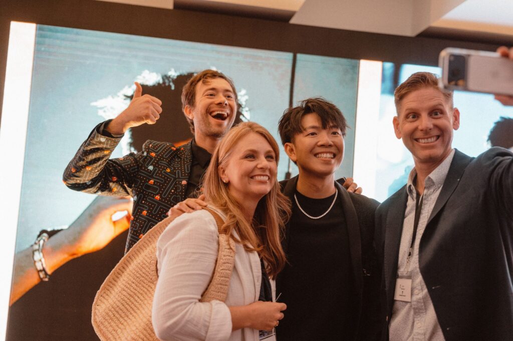 Conference guests take a selfie with Johnny Wu and Omni Magic magician Dylan after the show