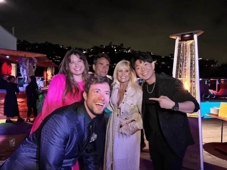 Johnny Wu with guests at a corporate rooftop event