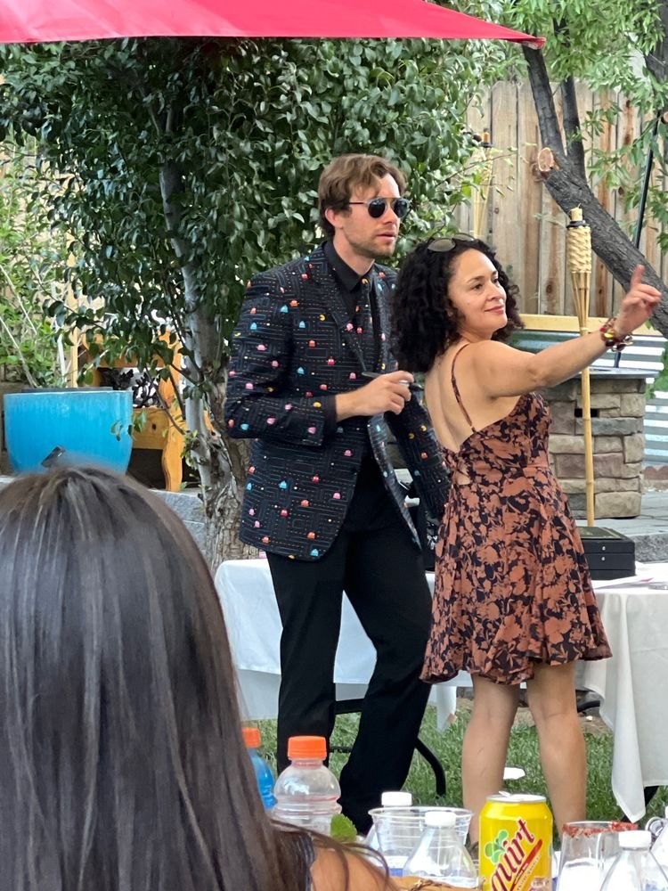 Dylan George with a volunteer at a backyard party