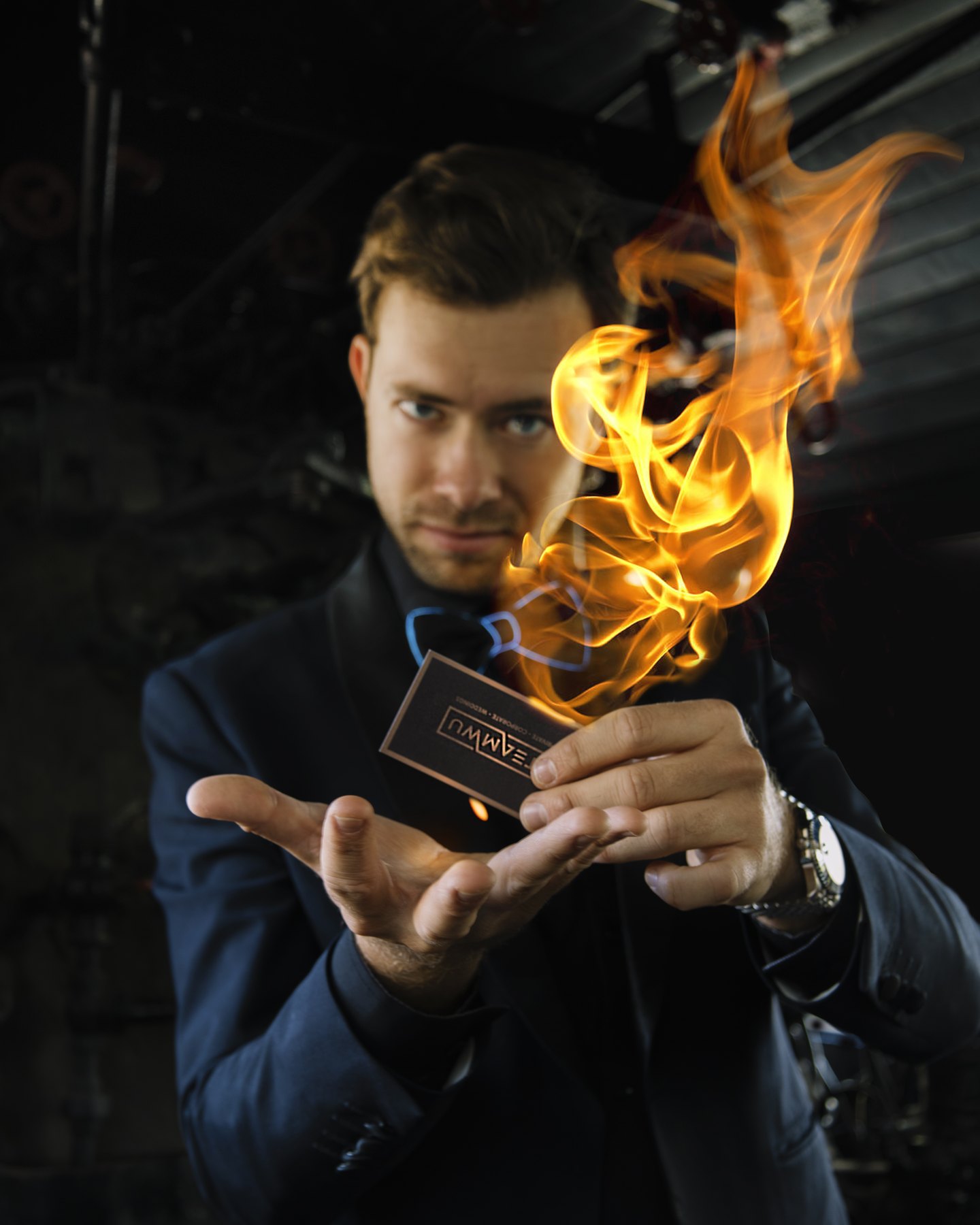 Dylan George holding a business card that bursts into flame