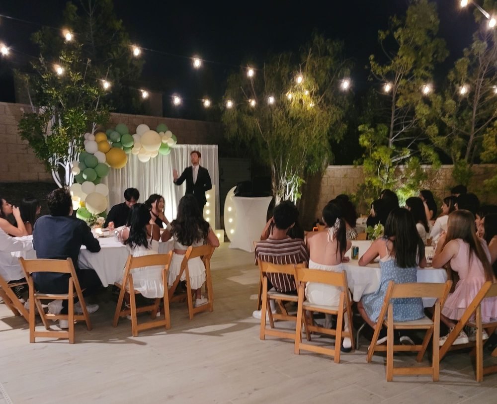 Dylan George addressing a captivated young audience outdoors