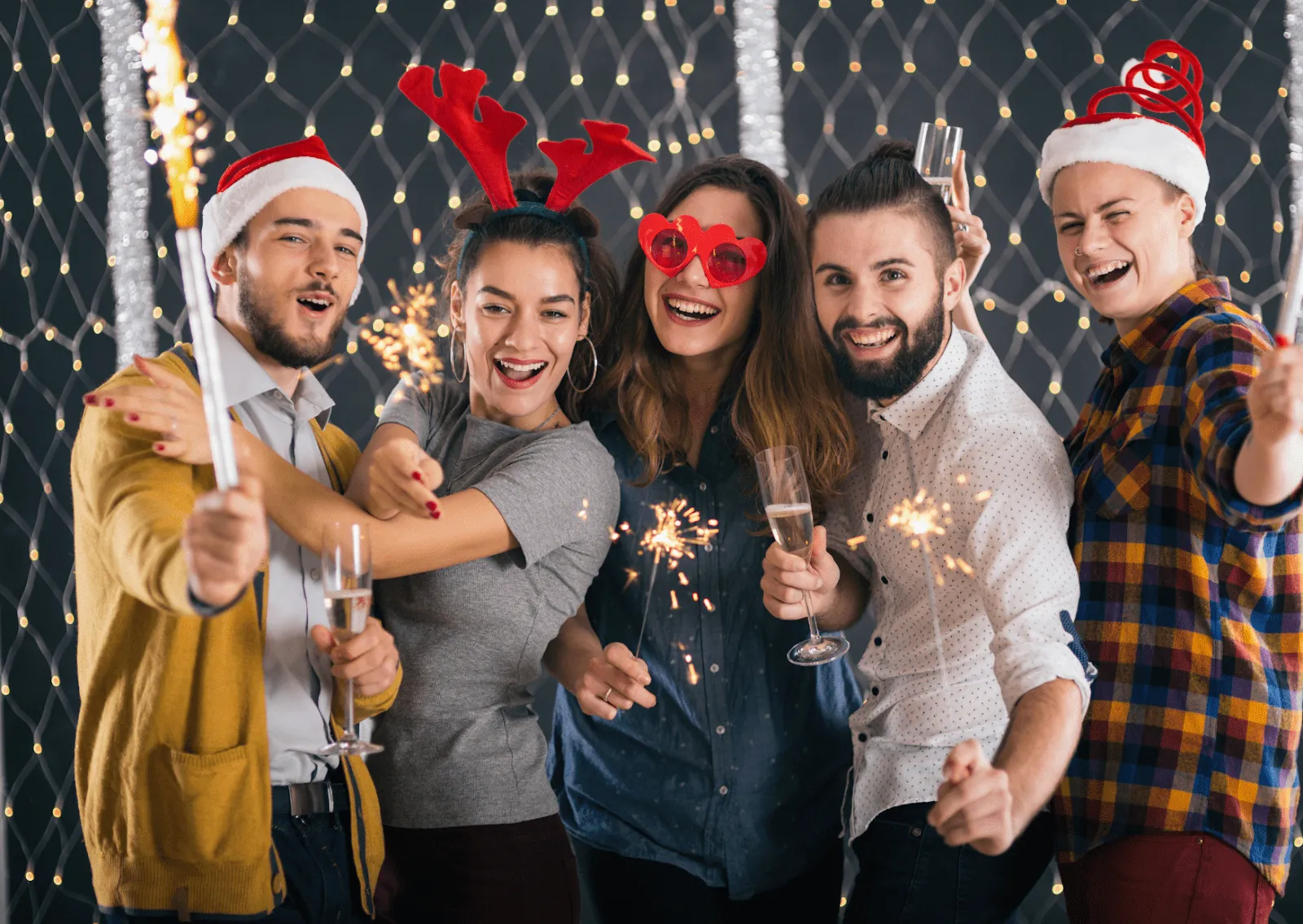 Friends celebrating at a Christmas party with sparklers