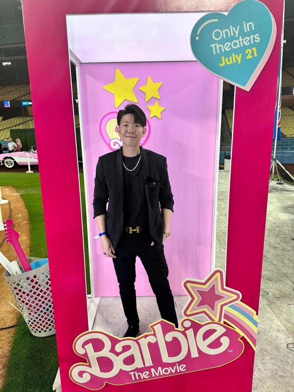 Johnny Wu posing inside a Barbie movie doll box display