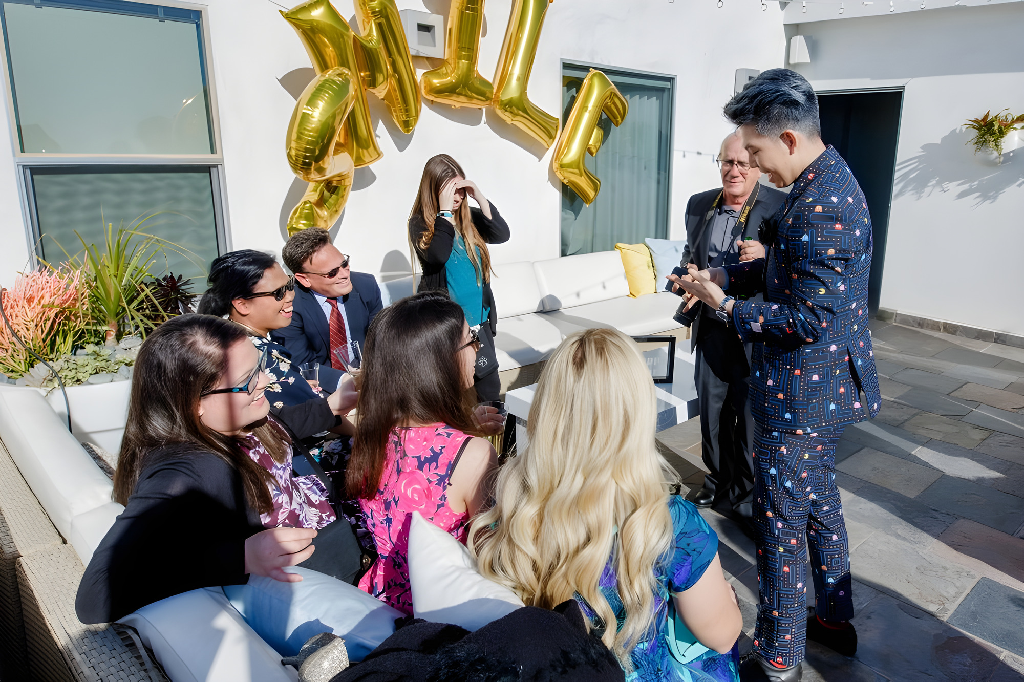 Johnny Wu performing for guests at a backyard house party, guests reacting