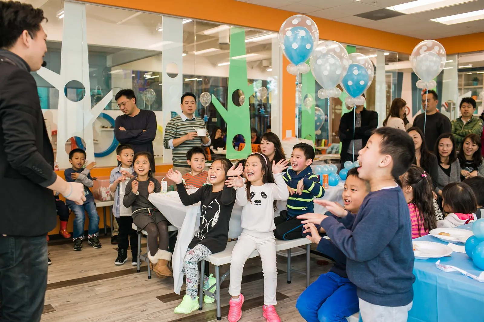 Children cheering during Johnny Wu's show at a kids birthday party