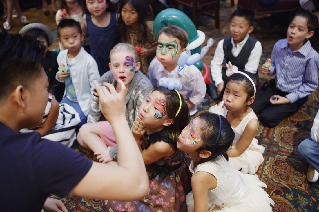 Johnny Wu performing a magic show for kids at a birthday party