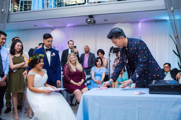 Johnny Wu performing magic for guests at a wedding