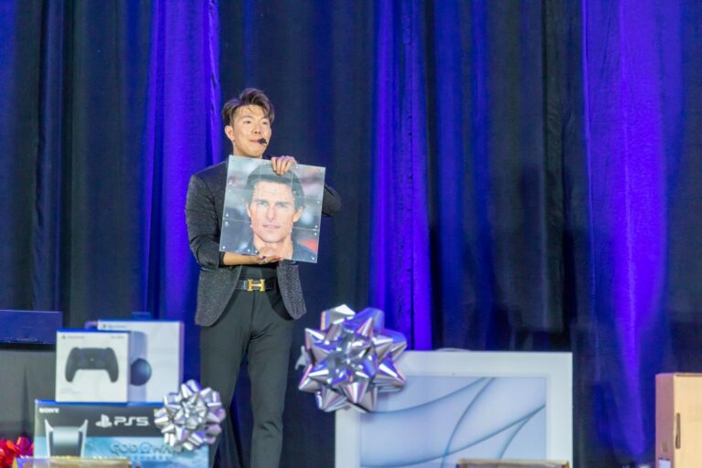 Johnny Wu performing on stage at a corporate event