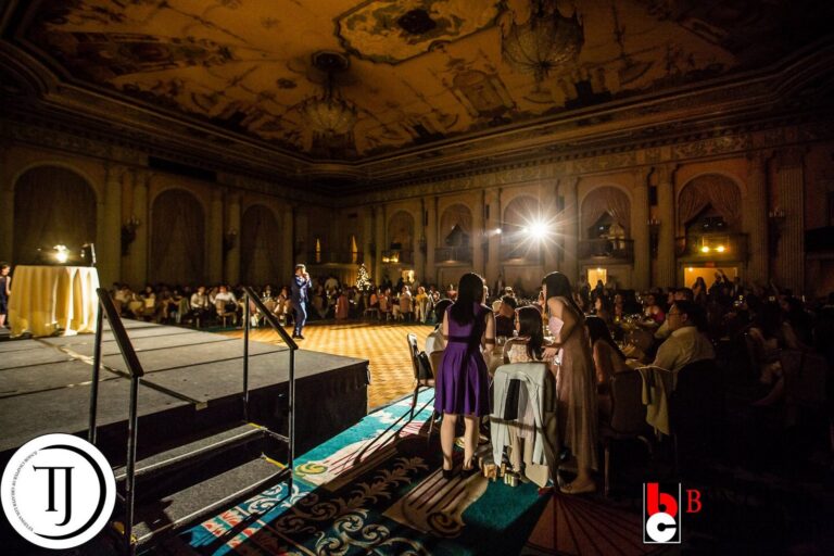 Johnny Wu performing on stage at a gala