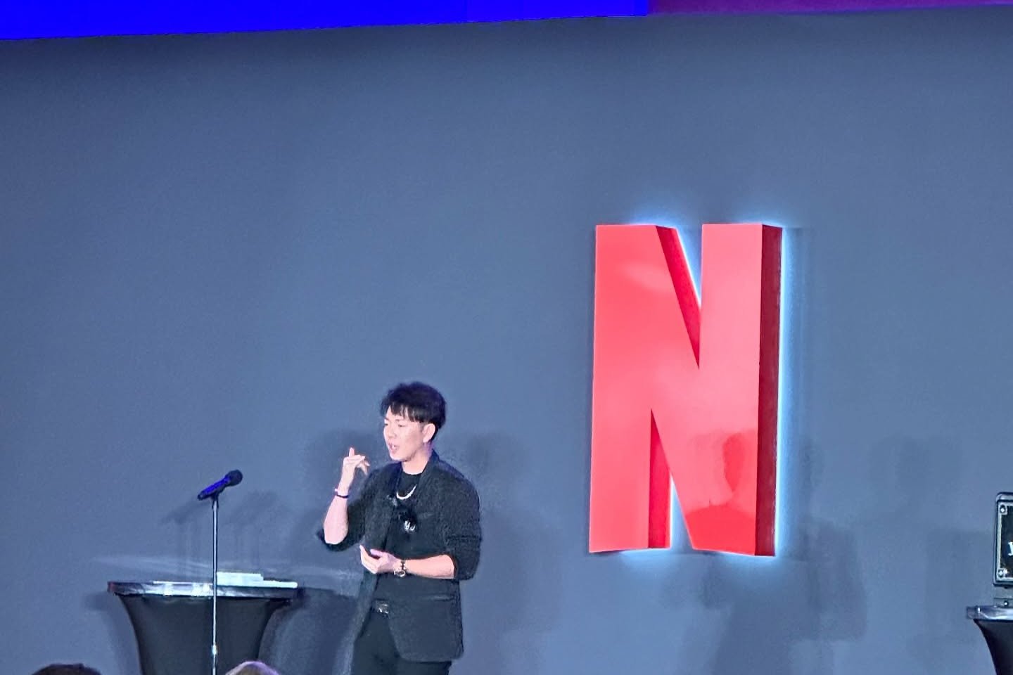 Johnny Wu performing on stage for Netflix