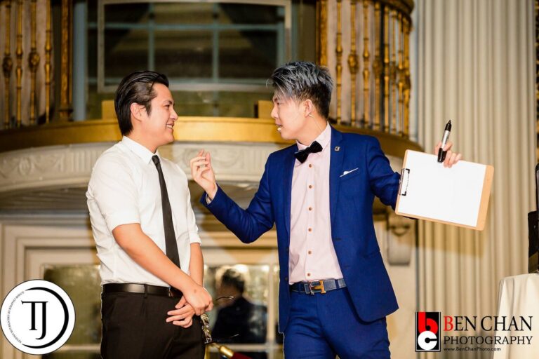Johnny Wu performing with a volunteer at a gala