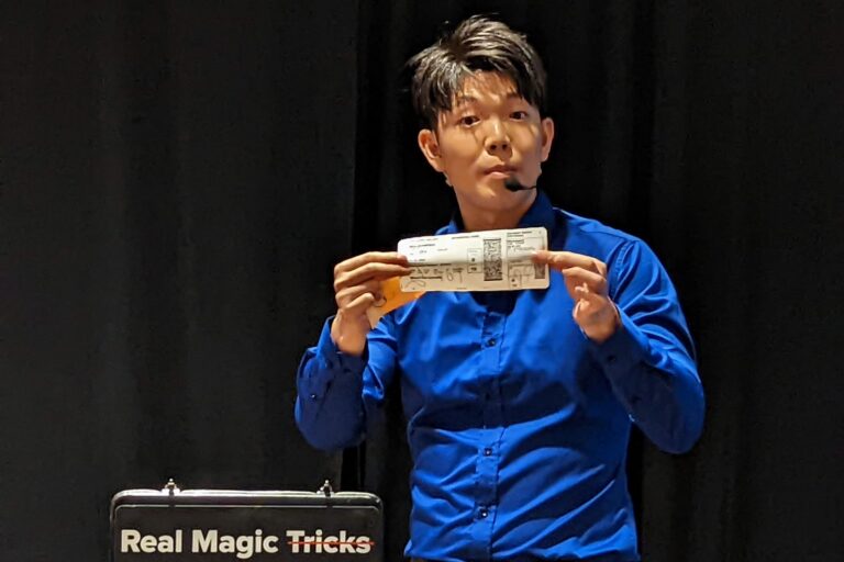 Johnny Wu reading a volunteer's mind on stage at a corporate event