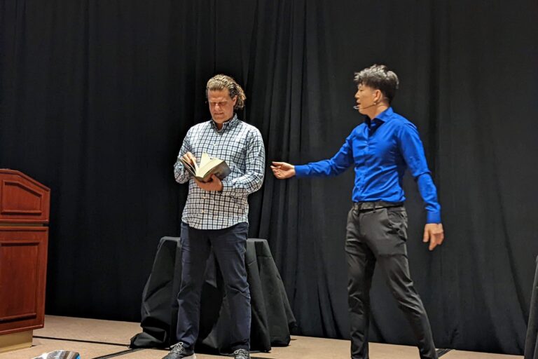 Johnny Wu reading a volunteer's mind on stage at a corporate event