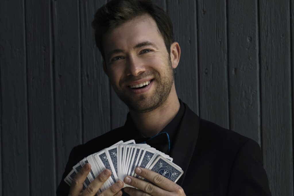 Omni Magic magician Dylan performing a card trick