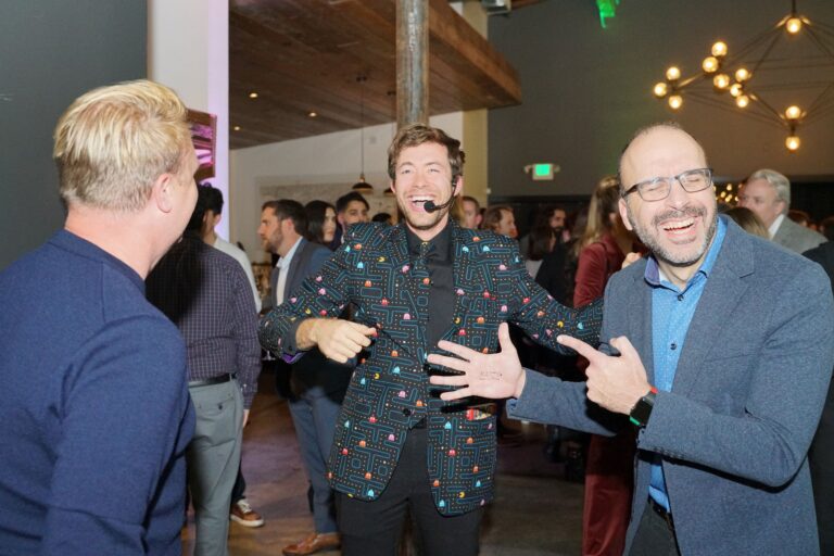Omni Magic magician Dylan performing strolling magic at a holiday party