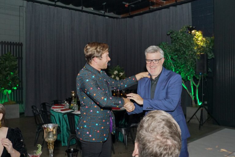 Omni Magic magician Dylan performing strolling magic at a holiday party