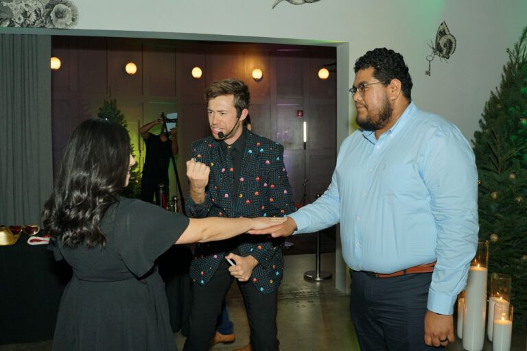 Omni Magic magician Dylan performing strolling magic at a holiday party