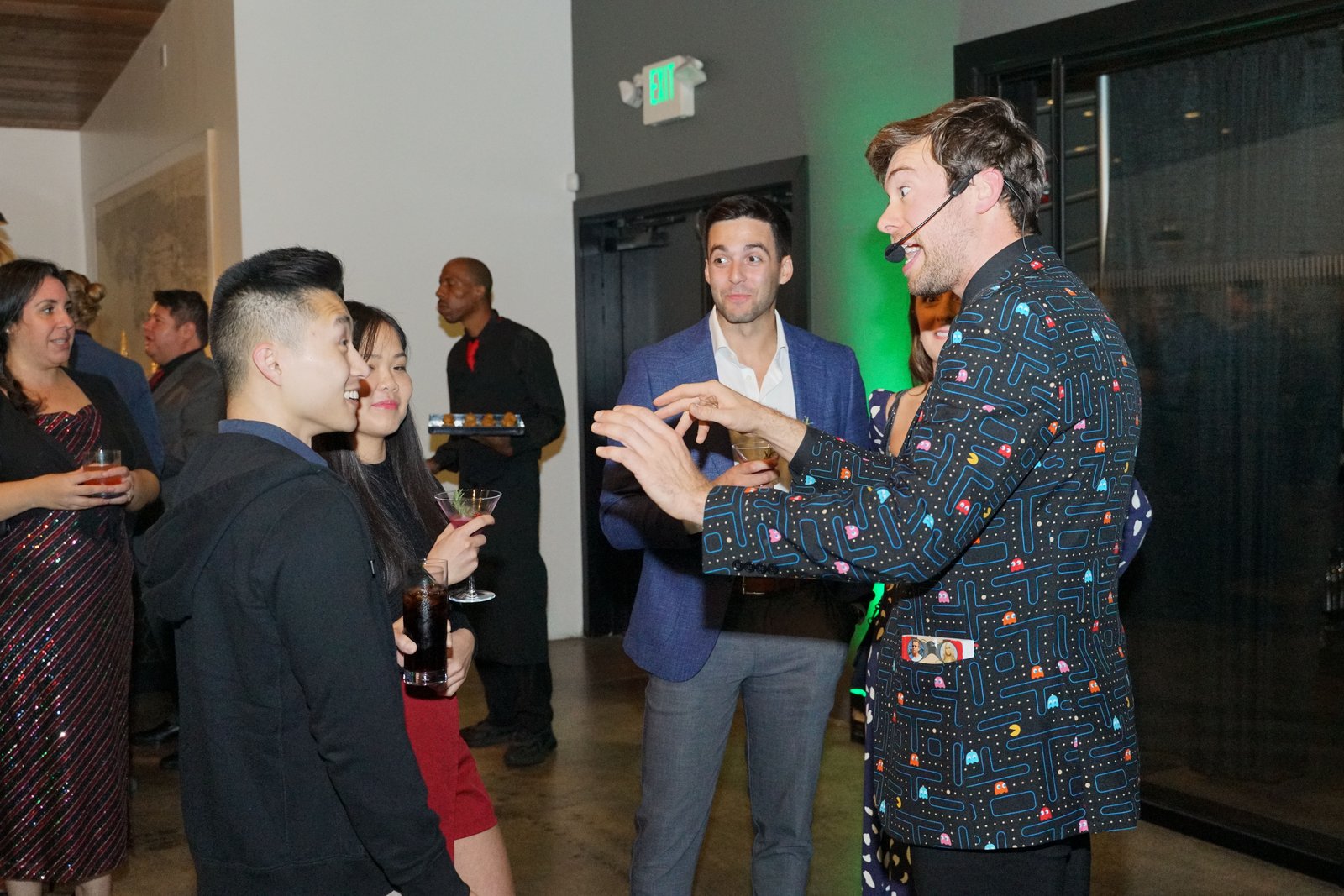 Omni Magic magician Dylan performing strolling magic at a holiday party